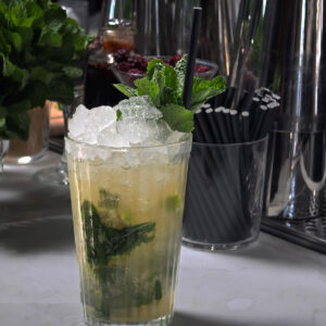 Mojito with mint garnish in highball and cane sugar