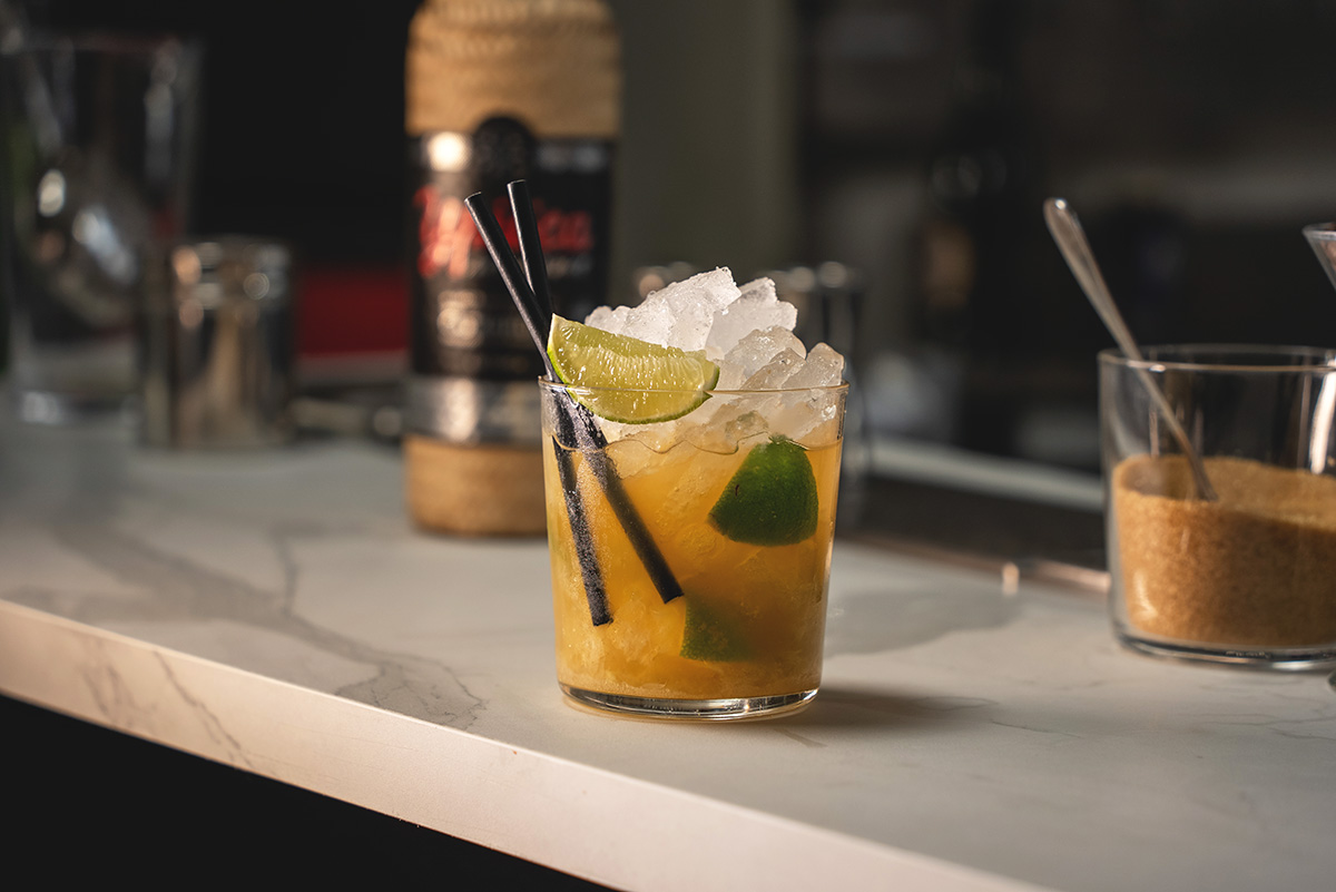 Caipirinha on a bar with a Cachaça in the background at EOW Magazine