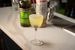 The cocktail Last Word on a bar at EOW Magazine