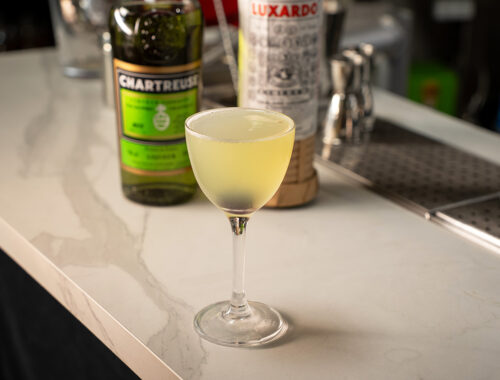 The cocktail Last Word on a bar at EOW Magazine